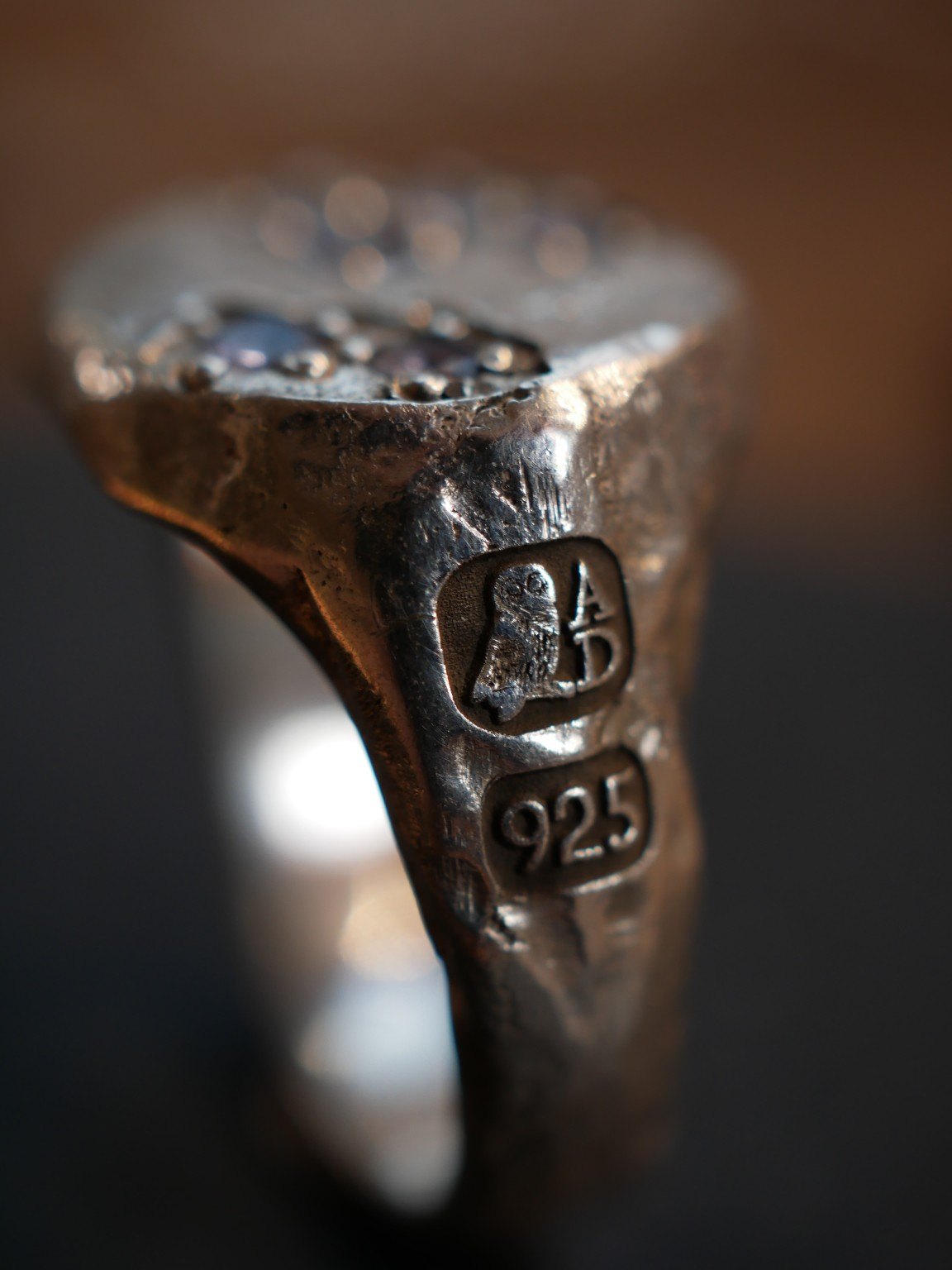 Close view of the Aurum Deorum owl and A.D. maker's mark engraved into a sterling silver ring